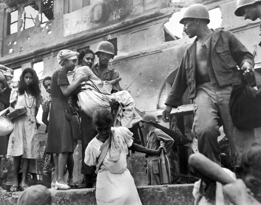 Filipino women are rescued from the Santa Clara Monastery in Manila by U.S. soldiers. The women had taken shelter in the monastery during heavy fighting of the Battle of Manila.